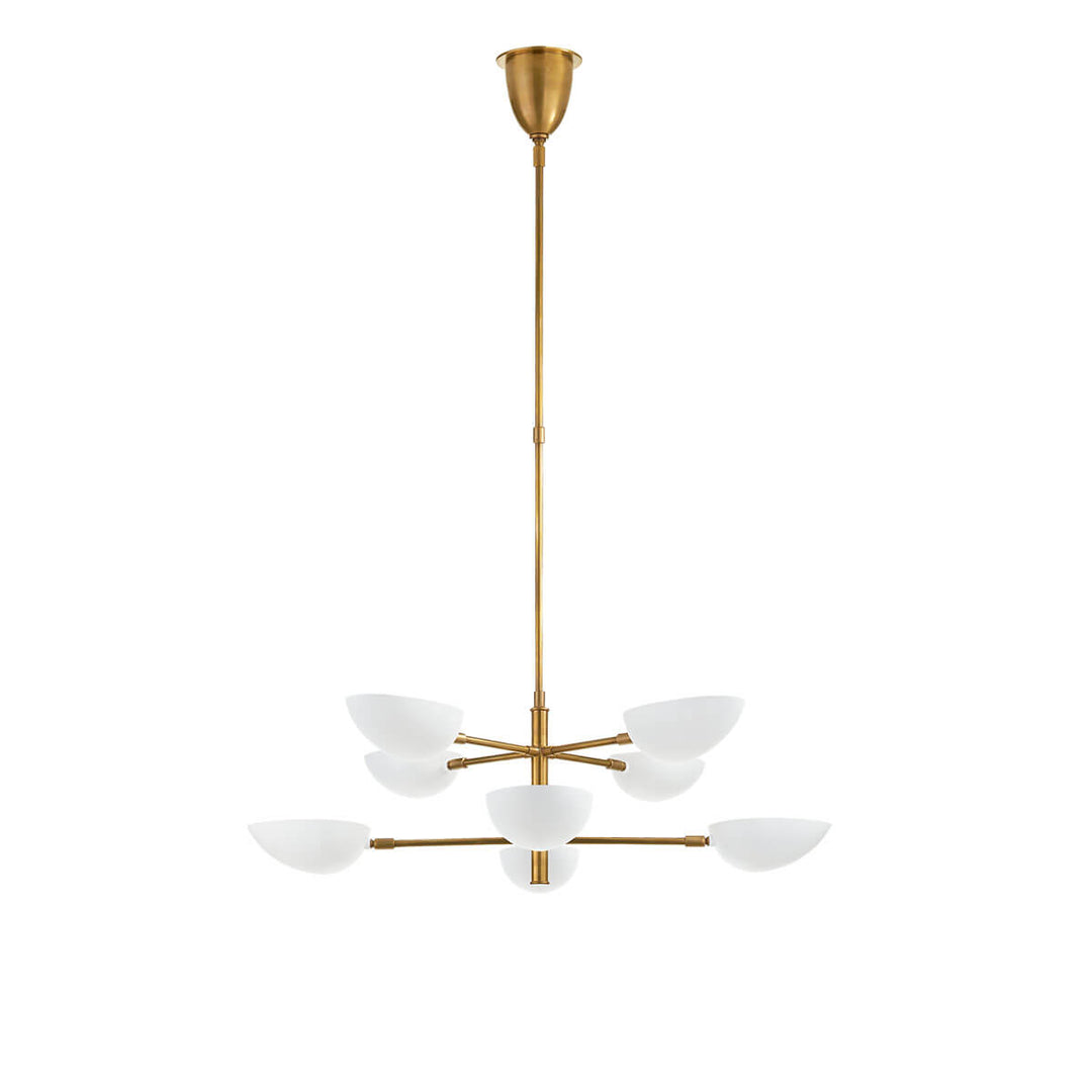 The Graphic Two-Tier Chandelier has eight, petal shaped matte white glass lights on a thin, hand-rubbed antique brass column with two tiers.