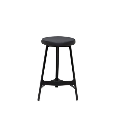 The Naha Counter Stool has a steel frame, slightly curved lines, and a faux leather seat.