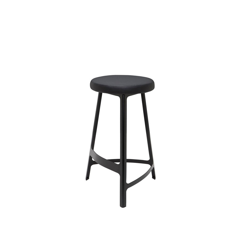 Black metal stool with slightly curved lines and a faux leather seat.