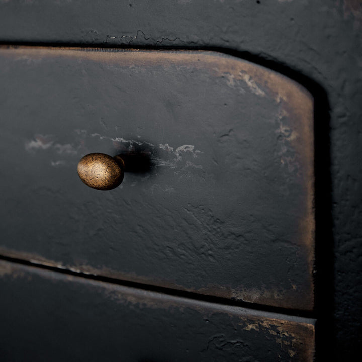 Close up of the burnished brass hardware and distressed wood on the heirloom nightstand.