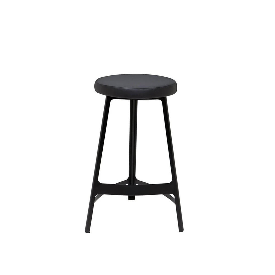 The Naha Bar Stool has a steel frame, slightly curved lines, and a faux leather seat.