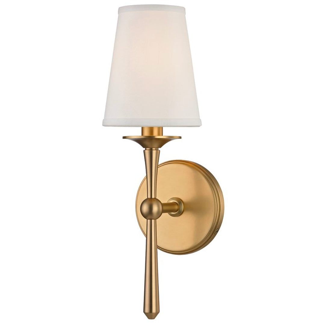 This traditional, aged brass sconce has antique features such as its bobeche candle sleeves, faux silk shade, and cast metal.