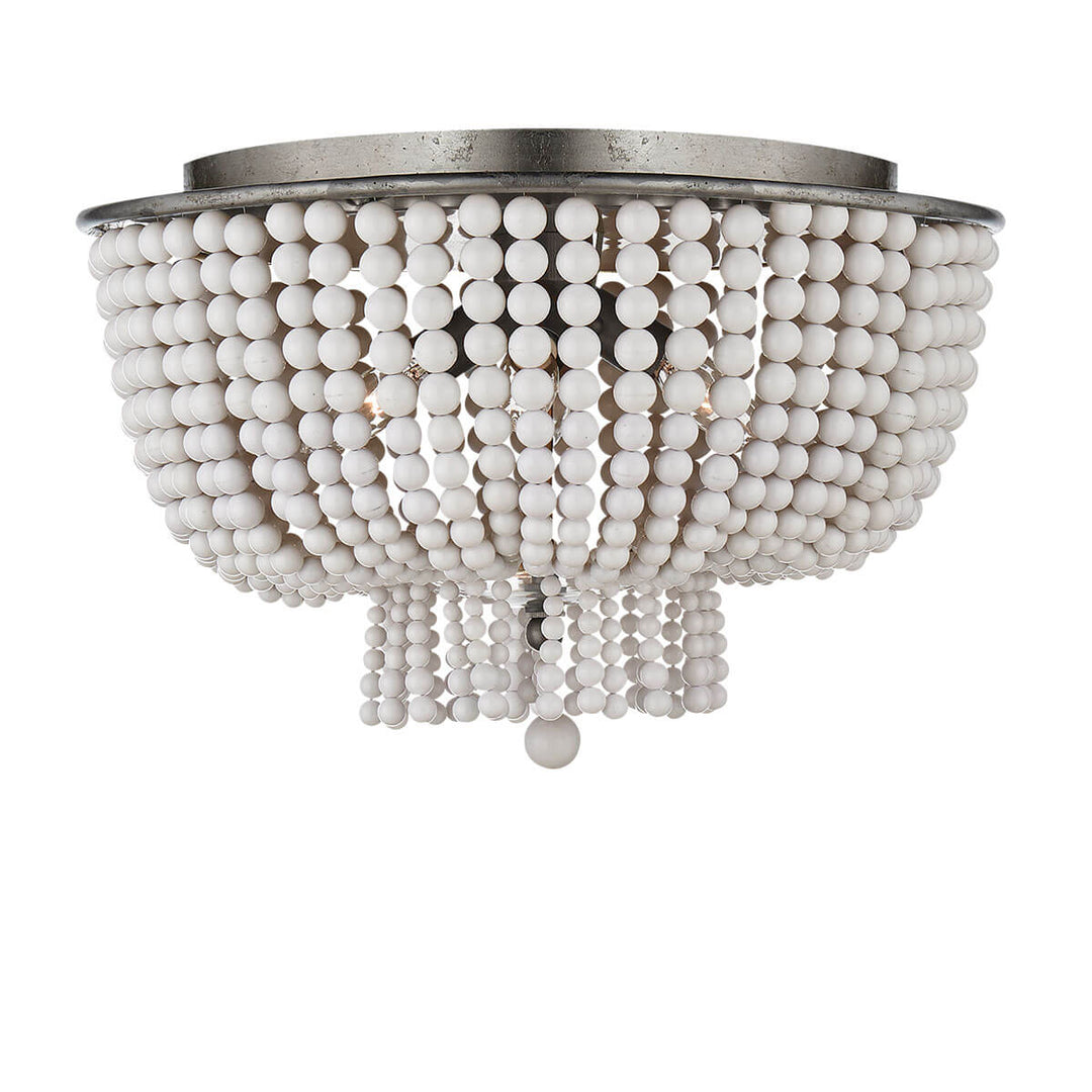 The Jacqueline Flush Mount has a silver leaf canopy and a pendant with strings of white acrylic beads.