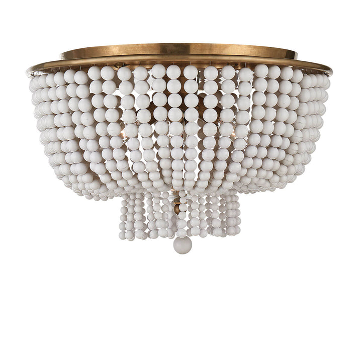 The Jacqueline Flush Mount has a hand-rubbed, antique brass canopy and a pendant with strings of white acrylic beads.