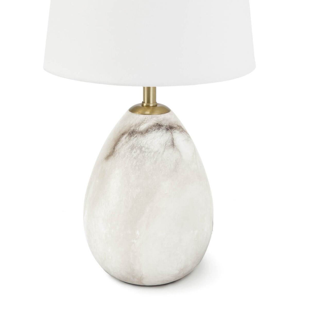 Simple table lamp with a tear drop shaped alabaster base and gold hardware.