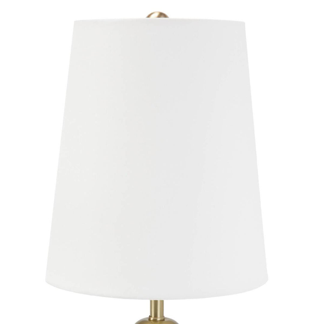White, elongated lamp shade on a simple, mini table lamp.