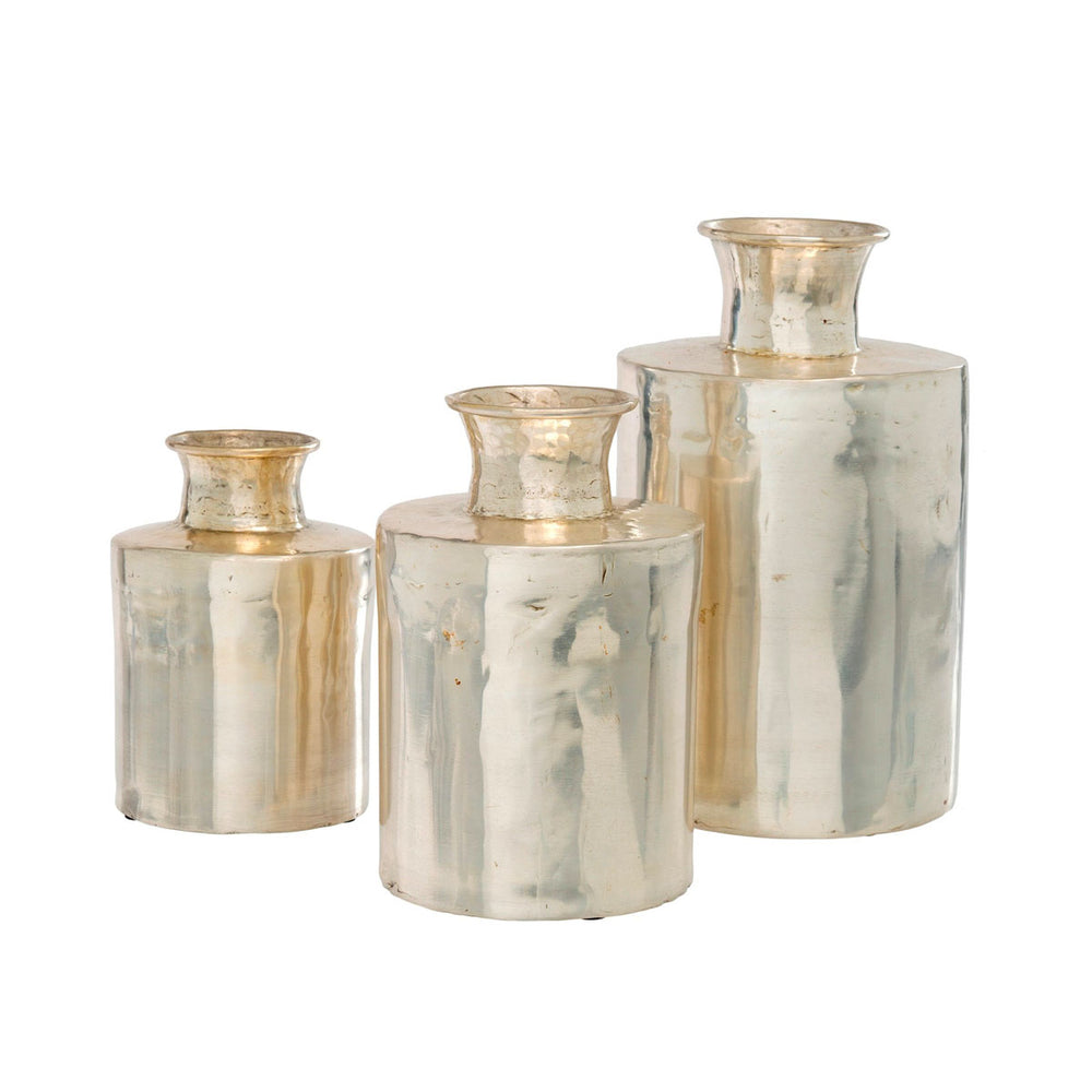 The Jesup Vases come in multiple sizes. Shown in a grouping. These decorative vases are made of brass and finished in a warm silver finish with antique patina.