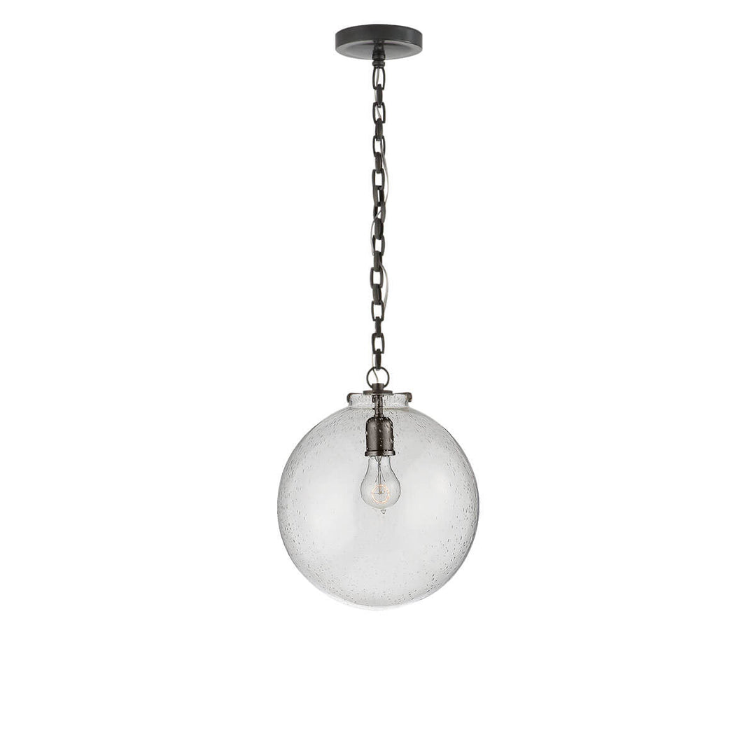 The Katie Globe Pendant is a seeded glass globe ceiling light with a bronze chain and hardware.
