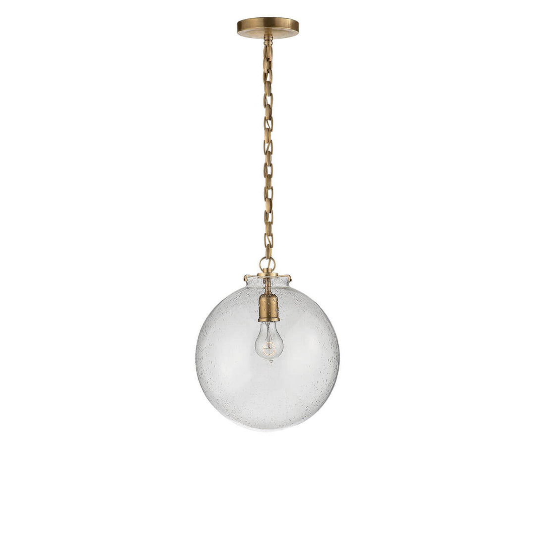 The Katie Globe Pendant is a seeded glass globe ceiling light with a hand-rubbed antique brass chain and hardware.