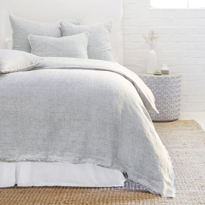 The Oaxaca Bedding Collection - Navy is a 100% linen duvet cover with heathered detail and frayed edges.