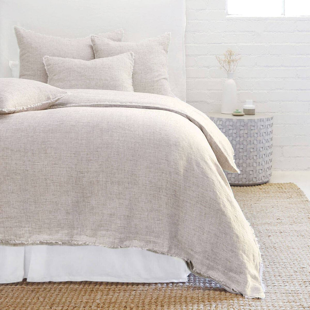 The Oaxaca Bedding Collection -Terra Cotta is a 100% linen duvet cover with heathered detail and frayed edges.