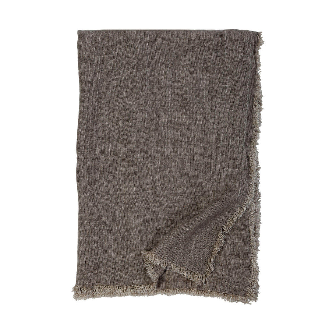 The Genoa Oversized Throw is an oversized dark brown throw with 100% linen with frayed edges.