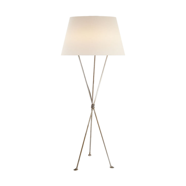 The Lebon Floor Lamp has three slim tripod legs in a burnished silver leaf finish with a white linen shade.