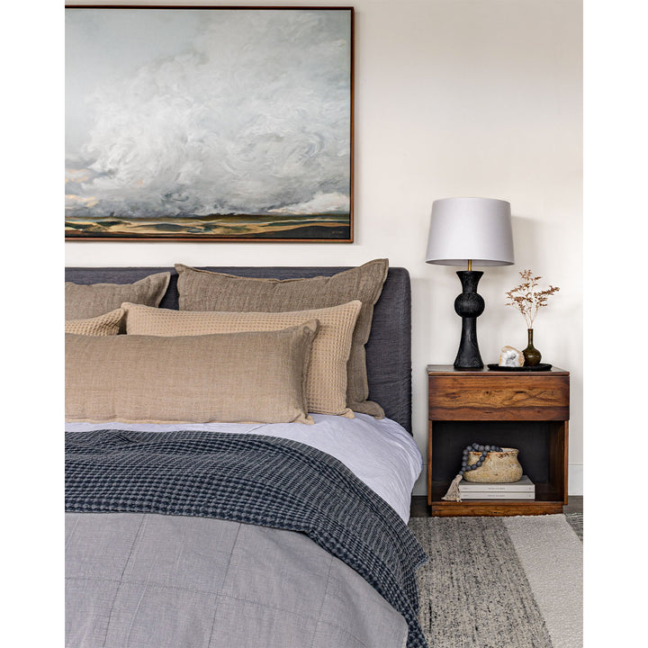 Textural bedding styled using warm and cool tones. Featuring the Leon Body Pillow in Natural.