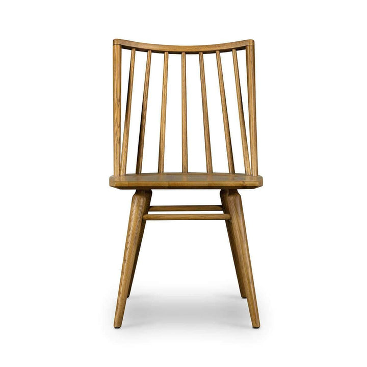 The Prineville Dining Chair is a solid wood chair with a rounded spindle back in a sandy oak finish.
