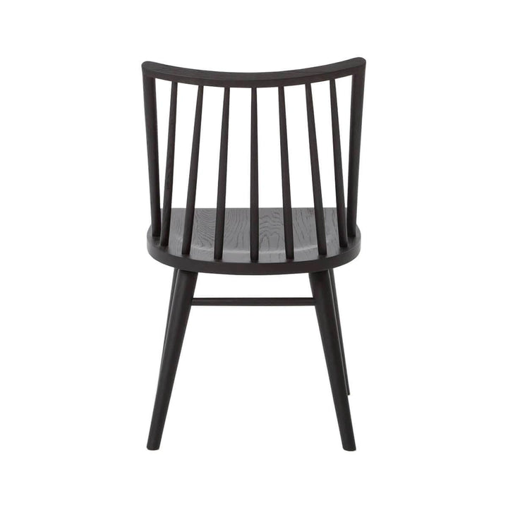 Back view of a traditional dining room chair with a rounded spindle back and tapered legs.