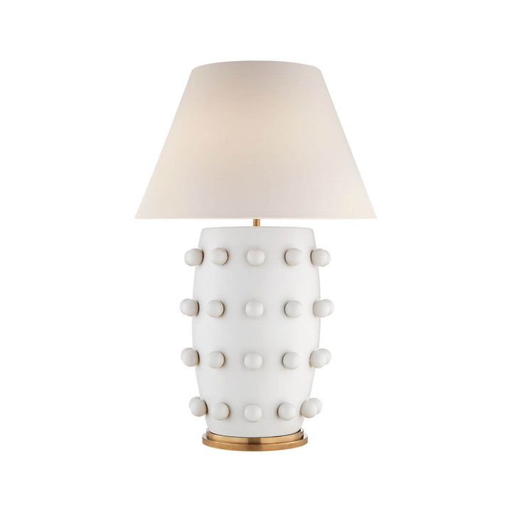 The Linden Table Lamp is a large statement lamp with a plaster white base with ball details and an off white linen shade.