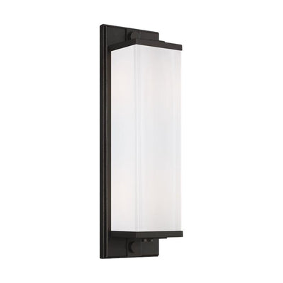 Minimalist wall sconce with a rectangular glass shade and an aged iron finish.