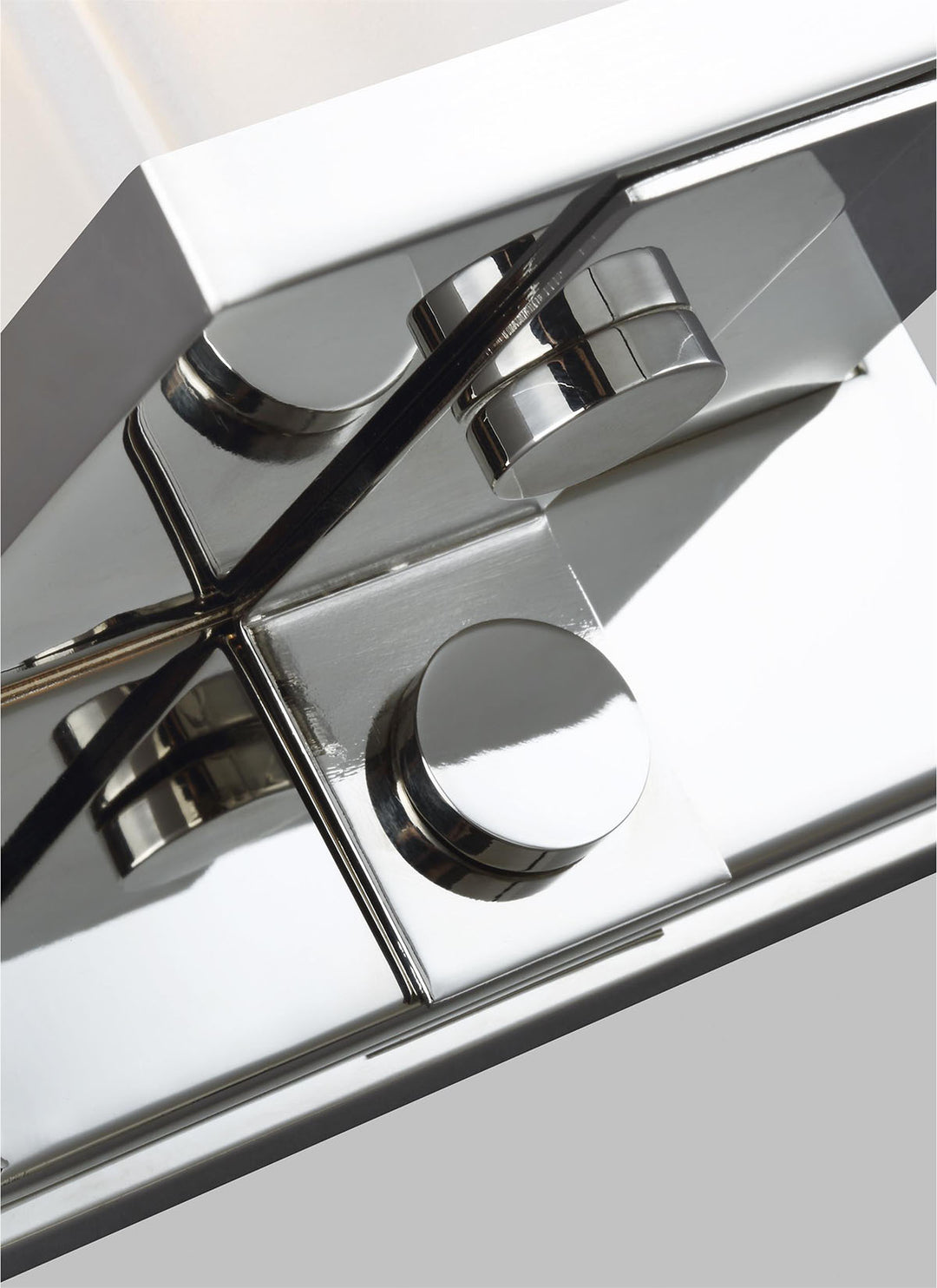 Polished nickel details on the minimal wall sconce with a rectangular light.