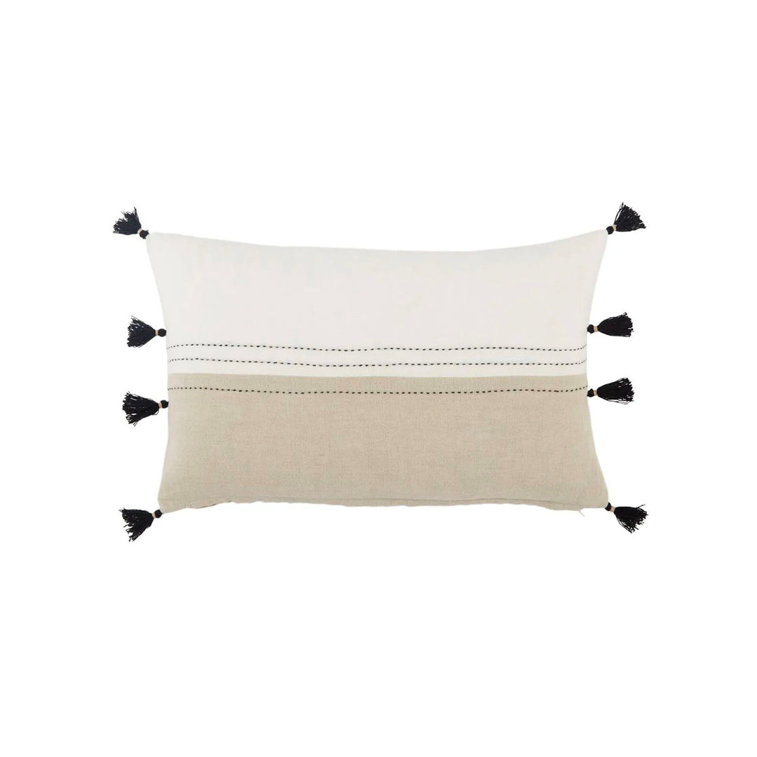 Indoor lumbar pillow with neutral tones and black stitching with black tassels.