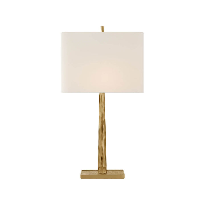The Lyric Table Lamp has a wood-like, textured body in a soft brass finish with a rectangular linen shade.