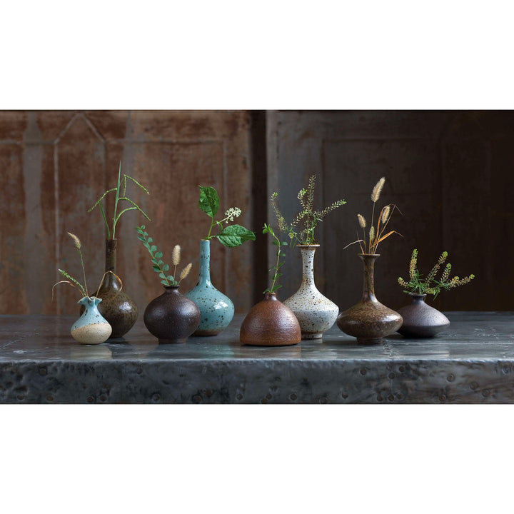Porcelain vases styled with greenery.