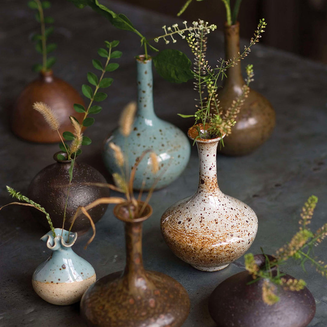 Ceramic vases with greenery and flowers.