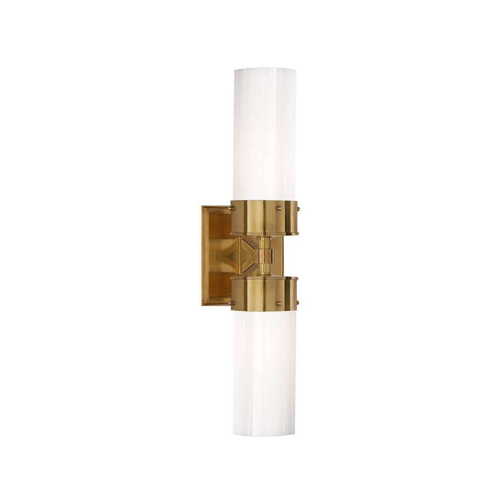 The Marais Double Wall Sconce has two white glass, cylindrical lamp shades and a hand-rubbed, antique brass square backplate and hardware.
