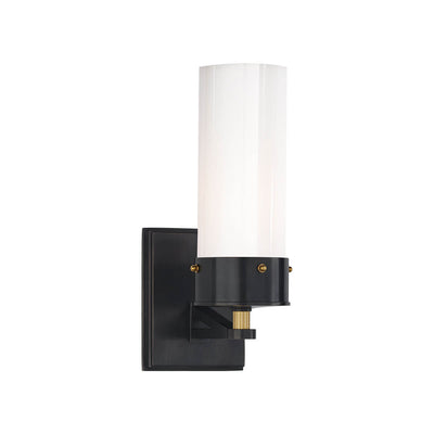 The Marais Wall Sconce has a bronze square backplate with antique brass details and covered bolts and a white glass cylindrical shade.