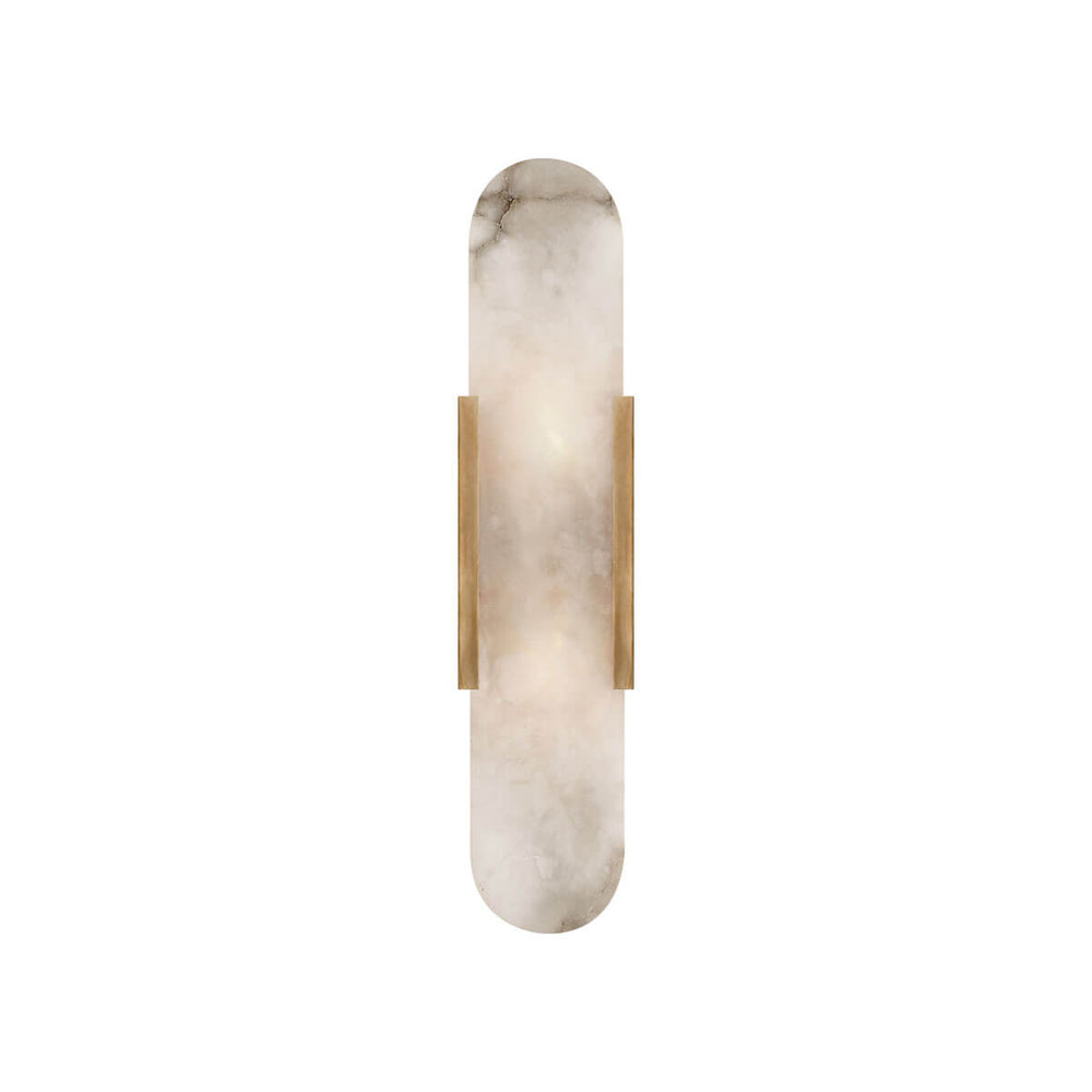 The Melange Elongated Wall Sconce has an alabaster shade with an antique burnished brass metal clip and backplate.