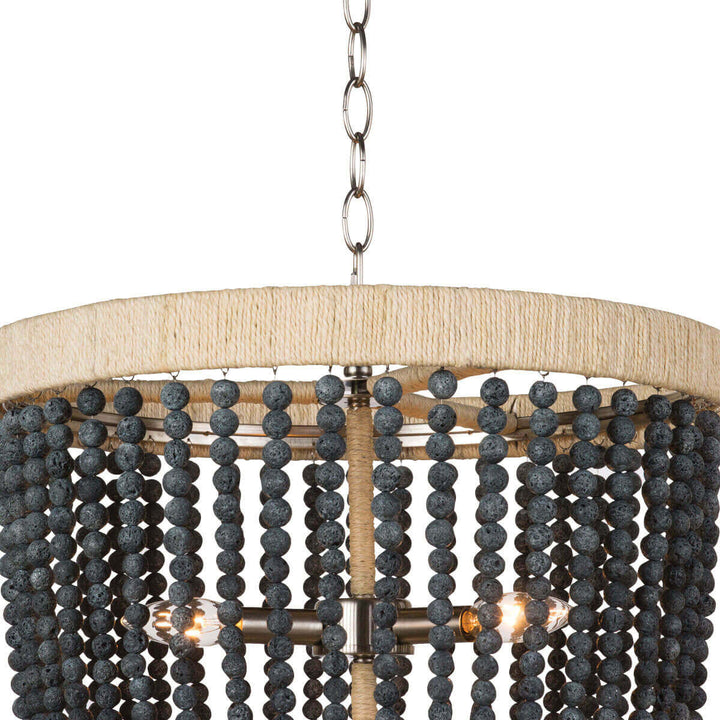 Closeup of the rattan-wrapped, metal frame and dark, round beads on the modern farmhouse chandelier.