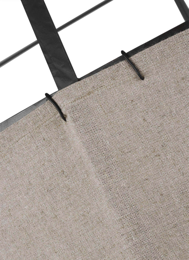 Natural linen shade with overstitching details on a medium dining room pendant.