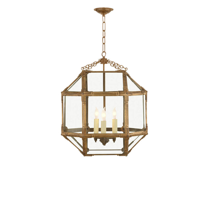 The Morris Medium Lantern has three candelabra lights in the middle of a gilded iron cage-like frame with visible joints and clear glass panels.