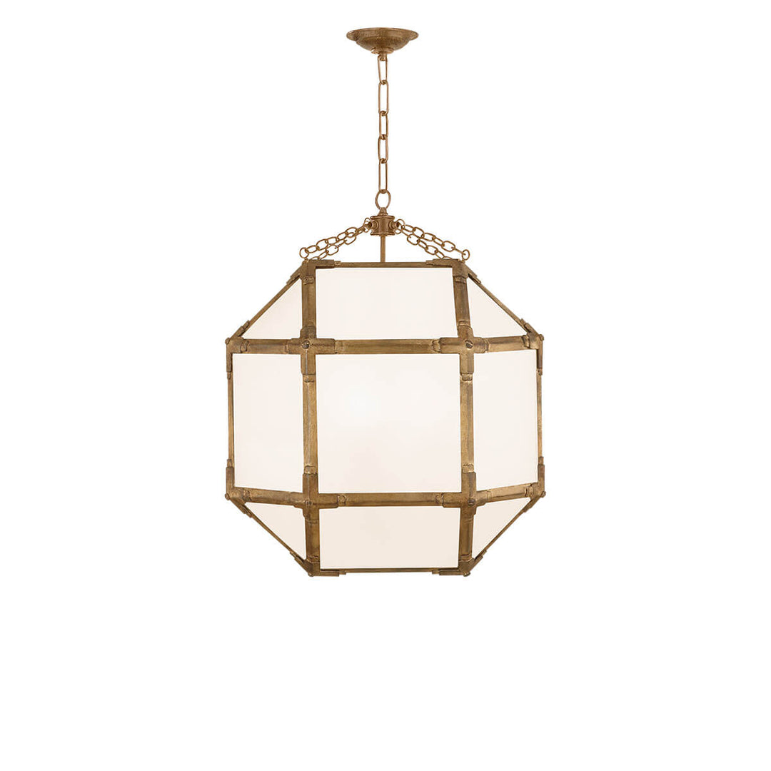 The Bruggen Medium Lantern has three candelabra lights in the middle of a gilded iron with visible joints and white glass panels.