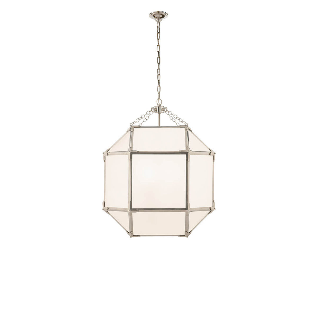 The Bruggen Medium Lantern has three candelabra lights in the middle of a polished nickel cage-like frame with visible joints and white glass panels.