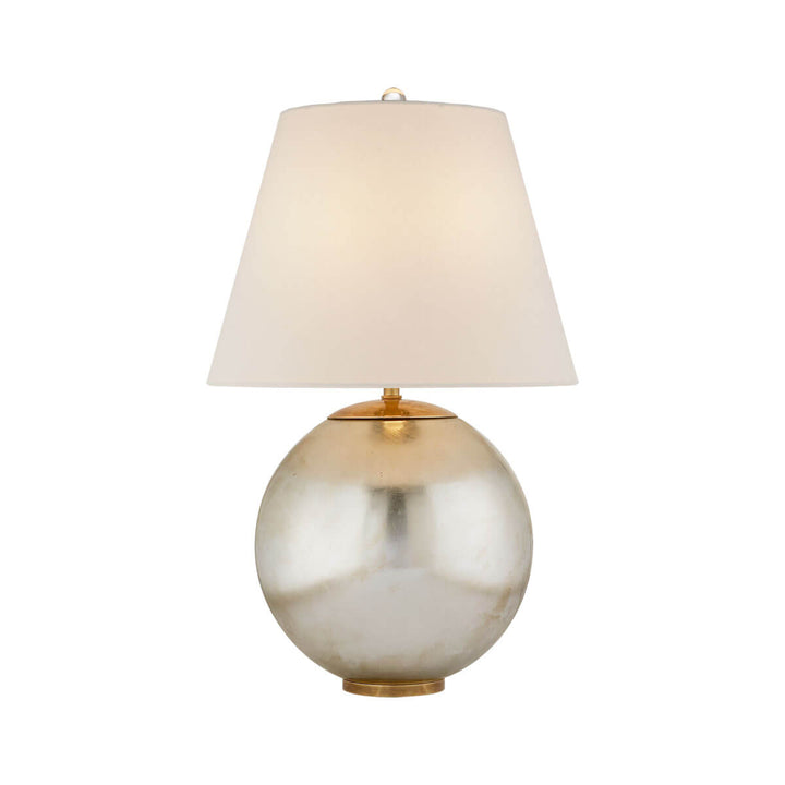 The Morton Table Lamp has a burnished silver leaf base and a tapered, linen shade.