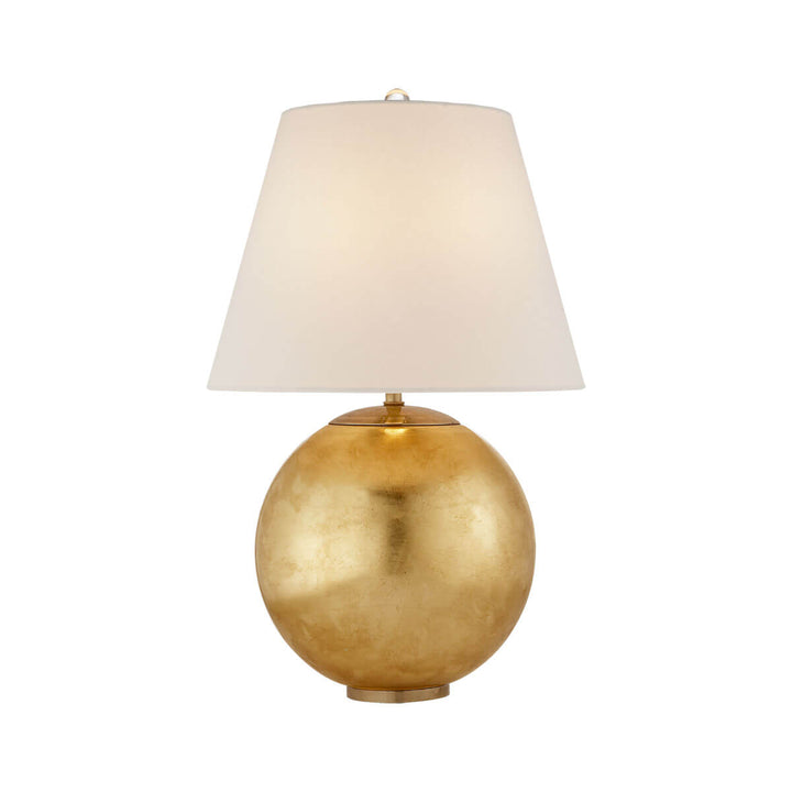 The Morton Table Lamp has a round, gild base and a tapered, linen shade.