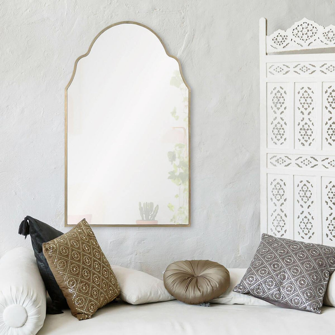 Old world glam mirror in a bohemian bedroom.