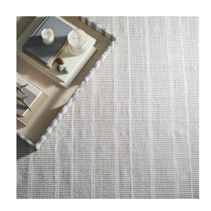 Grey Indoor / Outdoor Rug. Striped grey and white rug made out of recycled plastic bottles, meant for a patio or entrance.
