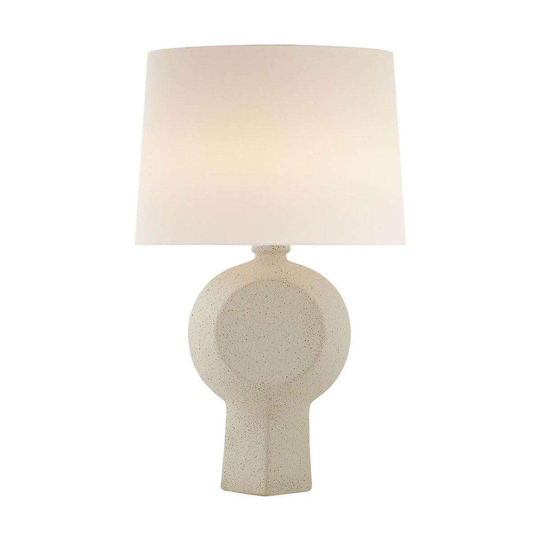 The Nicolae Large Table Lamp is a modern, ceramic table lamp with a speckled ivory finish and a white linen shade.