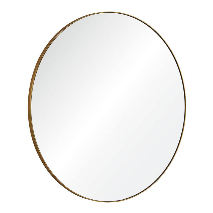 Modern, statement mirror with a round, gold frame.