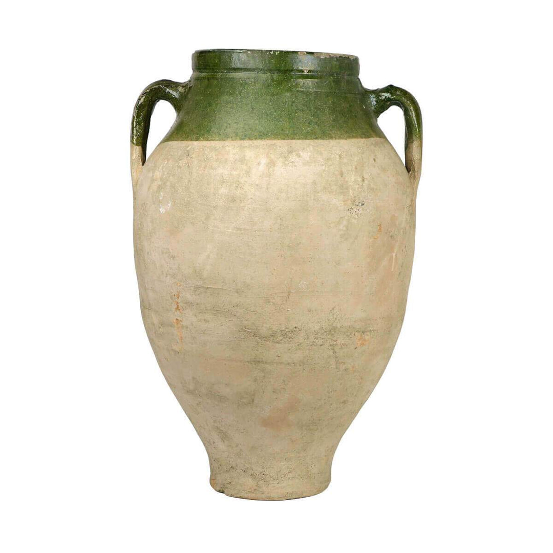 Large clay jar with two handles and with dark green glaze and unique marking details.
