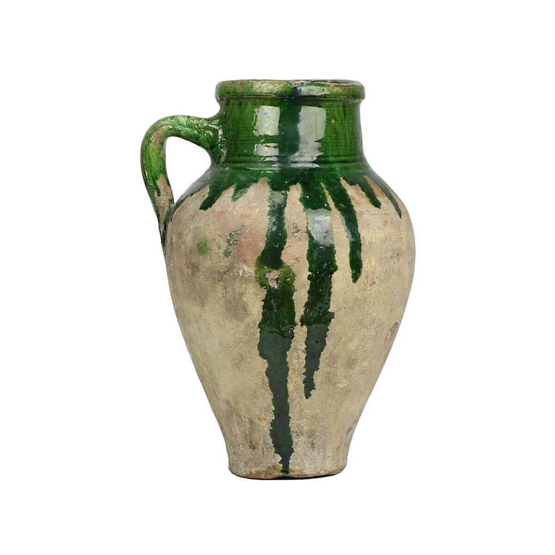 Unique clay jar with green glaze details and unique markings.