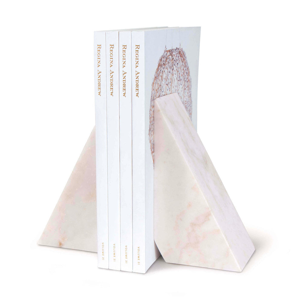 Modern marble bookend holding up books.
