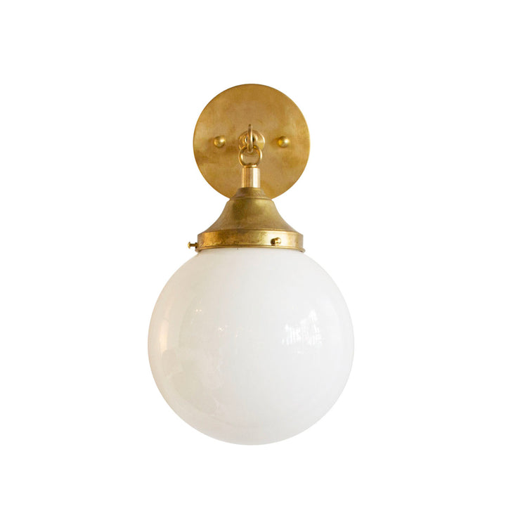 Hand Rubbed Antique brass hardware with orb globe light and opal glass. Meant for a bathroom or hallway.