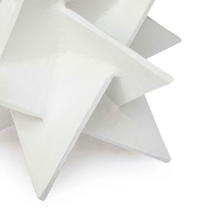 Base of white origami star sculpture made of aluminum.