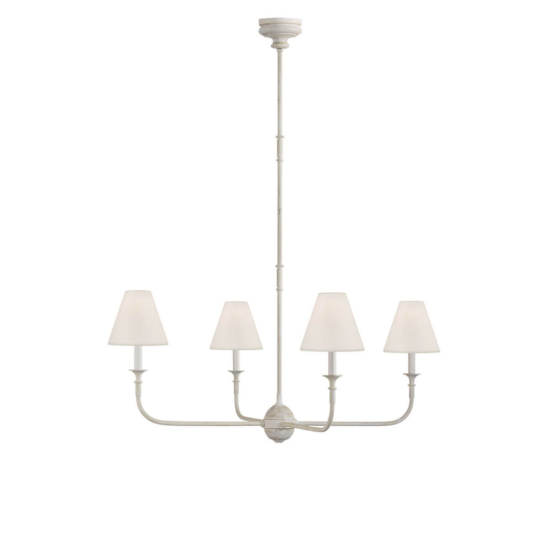 The Piaf Chandelier is a classic candelabra shaped chandelier with four small lights with linen shades and a metal frame in a Swedish grey finish.