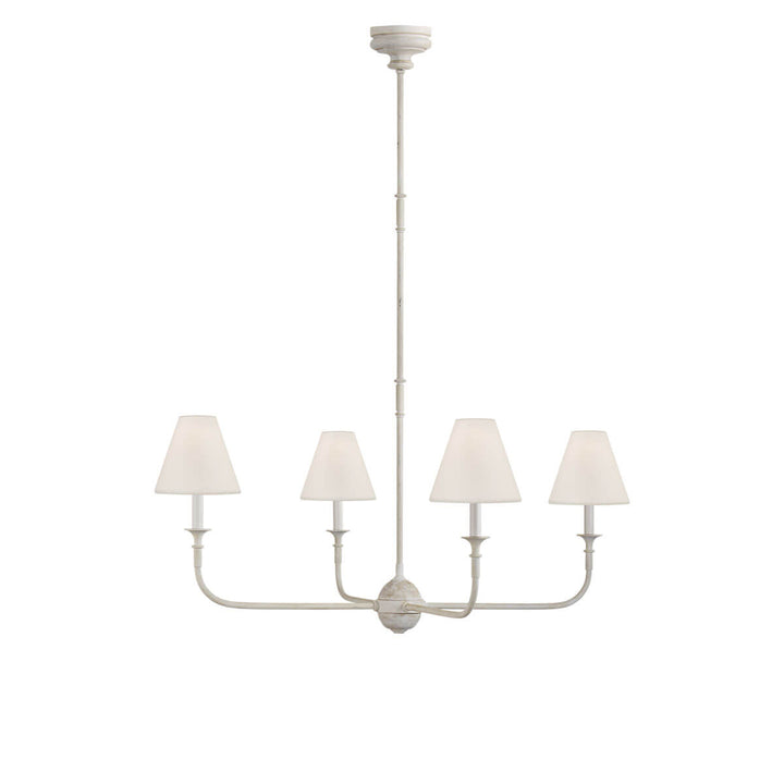 The Piaf Chandelier is a classic candelabra shaped chandelier with four small lights with linen shades and a metal frame in a Swedish grey finish.