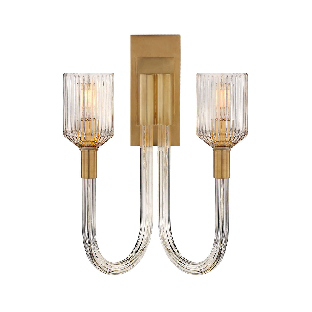 The Reverie Double Wall Sconce is finished in a glamorous antique burnished brass with clear ribbed glass for a traditional vintage charm.