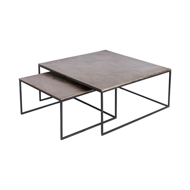 Modern nesting tables with a black frame and top with an antique brass finish.